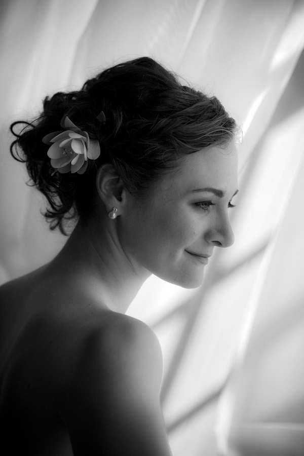 black and white photo of the beautiful bride wearing her hair in a updo with a floral hairpiece - photo by Washington DC based wedding photographers Holland Photo Arts